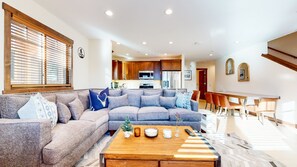 Relax in this inviting living space with a comfortable sofa, dining area, and fully equipped kitchen.