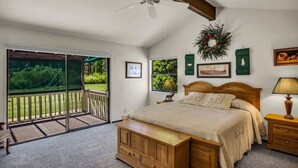 A bedroom with a large bed, a ceiling fan, a view through a sliding glass door, and a wreath on the wall. - Views of the 8th Fairway at Plumas Pines-8 Aspen (Blairsden)