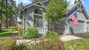 A two-story house with a garage, surrounded by a well-maintained lawn and trees. - Stunning on the 17th Fairway - 119 Cottonwood Dr (Blairsden)