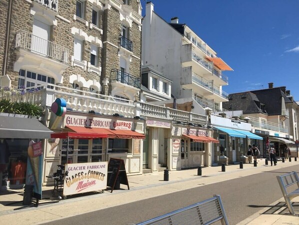 Una calle con varias tiendas, incluyendo Glacier Fabricant y Glaces & Cornets.