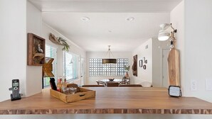A spacious dining area with a wooden table, chairs, and a decorative centerpiece.