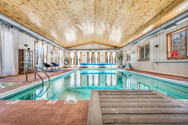 Indoor heated salt water pool year round, doors open to outside in summer