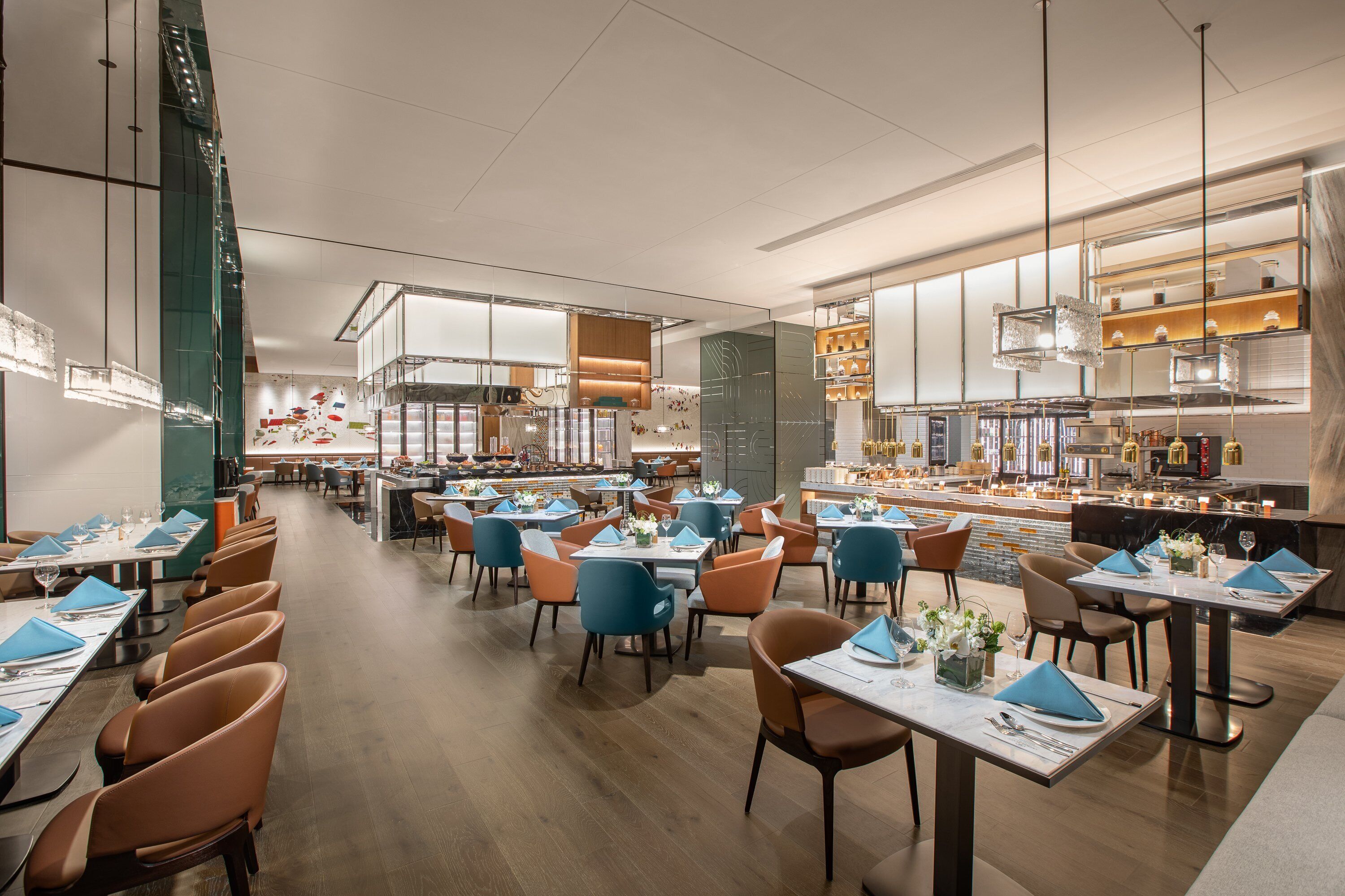 A spacious restaurant with multiple dining areas, modern lighting, and a clean, contemporary design.
