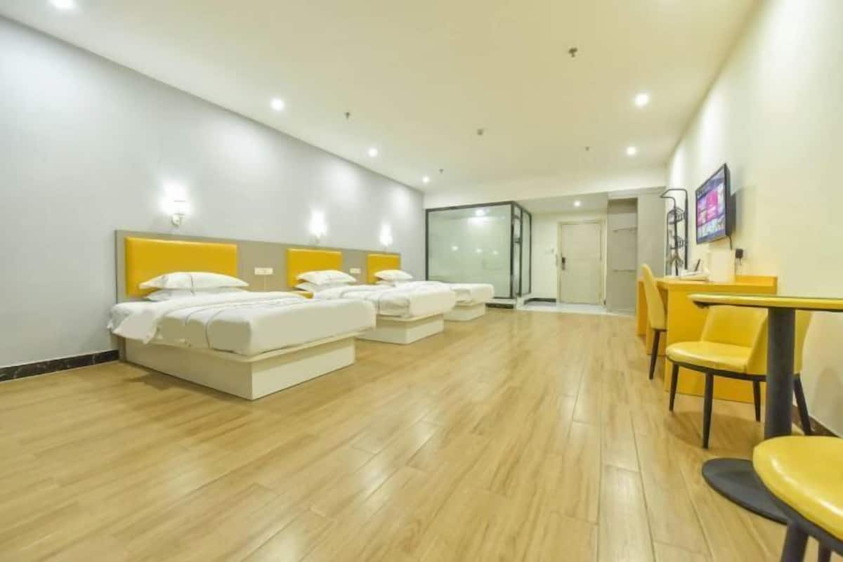 A hotel room with a bed, a desk, and a chair.