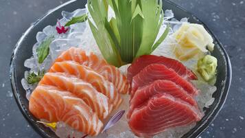 A plate of sushi with various types of fish and garnishes.