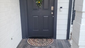 A dark grey door with a wreath, a doormat, and a small window above it. - 3 Bdr/2 Bth home between Katy and Houston close to HWY 10 and Green house  (Katy)