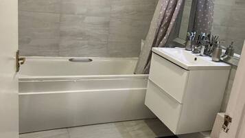 Combined shower/bathtub, hair dryer, bathrobes, towels