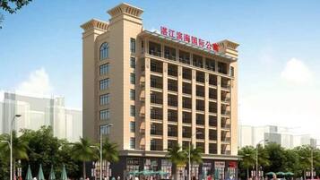A multi-story hotel with a prominent entrance and signage.