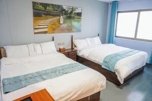 A hotel room with two single beds, a painting on the wall, a window with curtains, and a wooden floor. - Fenglai Holiday Hostel (Foshan)