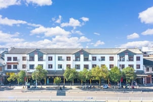 Fileira de edifícios tradicionais com um pátio central, provavelmente um hotel ou edifício público.