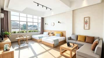 A modern hotel room with a large window, a sofa, a bed, a desk, and a coffee table.