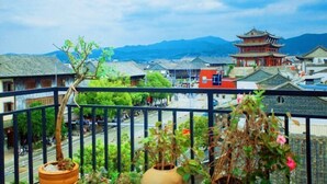 A traditional building with a multi-tiered roof, surrounded by greenery and a clear sky. - Yanchaoyang Boutique Inn (Jianshui)