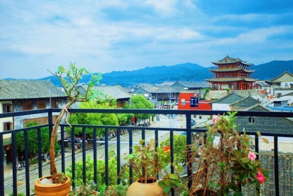 A traditional building with a multi-tiered roof, surrounded by greenery and a clear sky. - Yanchaoyang Boutique Inn (Jianshui)