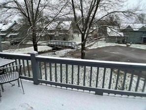 Enjoy a serene winter scene from the comfort of this cozy home's deck, overlooking the snow-covered neighborhood.
