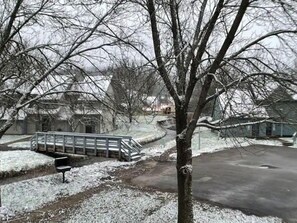 Stroll up the metal staircase to an entrance, set amidst a serene winter landscape.