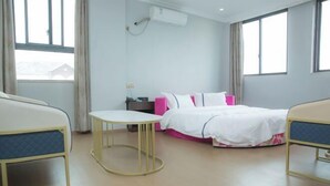A hotel room with a bed, bedside table, and a window. - edinburgh hotel (Haining)