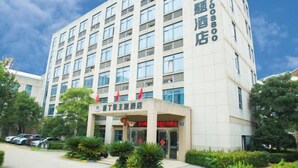 A multi-story hotel with a modern facade, featuring a prominent entrance with a sign. - edinburgh hotel (Haining)