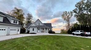 A two-story house with a garage, a driveway, and a lawn.