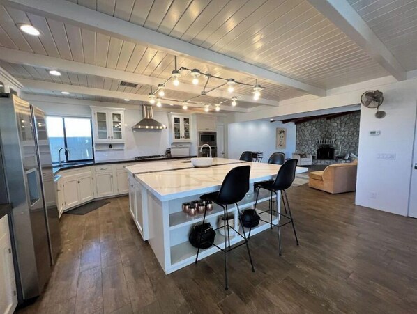 Enjoy cooking in this kitchen with a large island, oven, and ample counter space.