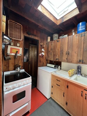 Enjoy cooking in this traditional kitchen with a stove, sink, and window above the sink.