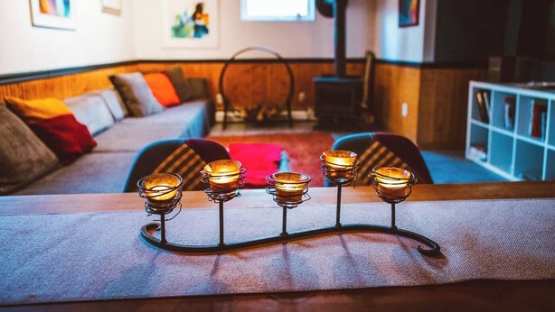 A cozy living room with a sofa, a coffee table with candles, and a fireplace. - Dream getaway apartment in the foot of Gunks Ridge (Wallkill)