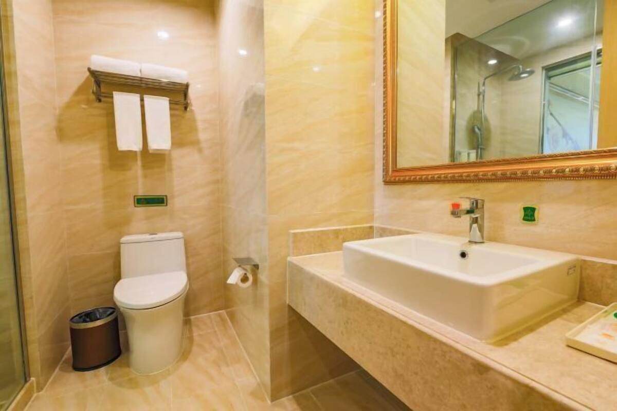 A modern bathroom with a toilet, bidet, and sink.