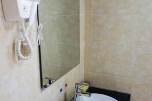 A bathroom with a hairdryer mounted on the wall, a mirror, and a sink with a faucet. - Qingcheng Mountain Qingcheng House Inn (Dujiangyan)