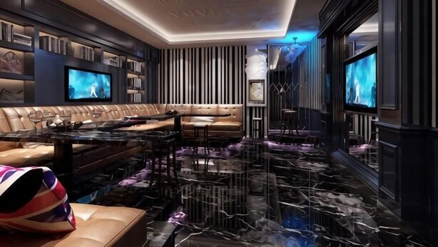 A modern living room with a sectional sofa, a flat-screen TV, a marble floor, and a bookshelf. - Beiliu Hyatt Hotel (Beiliu)