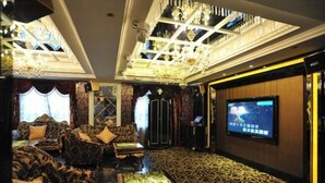 A luxurious room with patterned carpet, plush seating, a large screen, and ornate ceiling details. - JIA HAO HOTEL INTERNATIONAL PLAZA WUHAN (Wuhan)