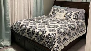 A bedroom with a bed, curtains, a ceiling light, and a fluffy rug. - Conveniently located 2brm / 1bt Home (Myrtle Grove)