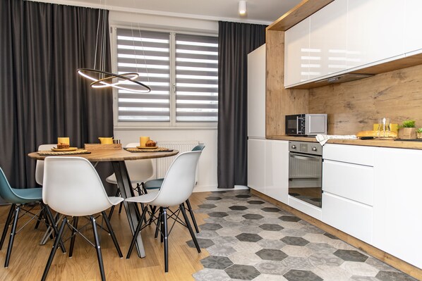 Enjoy meals in the kitchen and dining area with a round table and microwave.