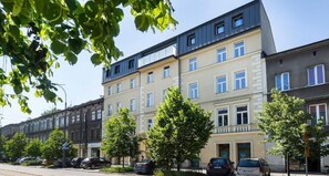 Stylish residential building with balconies and a quiet neighborhood setting.