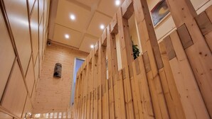 Una scala in legno dal design moderno, con una parete in legno su un lato e una porta sul fondo.