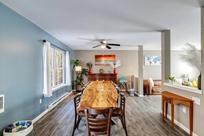 Enjoy meals in this dining area with a long table and comfortable seating.