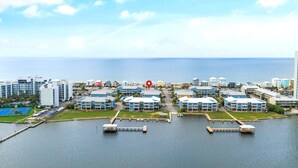 A coastal hotel area with multiple buildings, a marina, and a tennis court. - Ocean View/Deeded Beach Access/Selfie Wall/Pets Ok! (Gulf Shores)