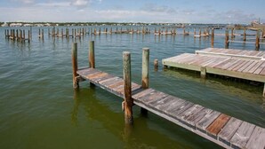 A wooden pier extending into calm water, surrounded by wooden posts. - Ocean View/Deeded Beach Access/Selfie Wall/Pets Ok! (Gulf Shores)
