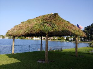 Situated by a serene body of water, this charming pavilion offers a peaceful retreat.