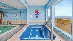 A pool area with a hot tub, a lifebuoy, and a sign indicating no diving. - Rockaway Beach Resort (Rockaway Beach)