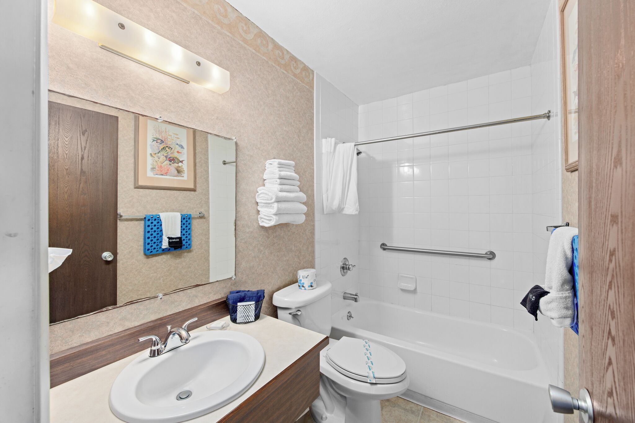 A modern bathroom with a sink, toilet, and bathtub.