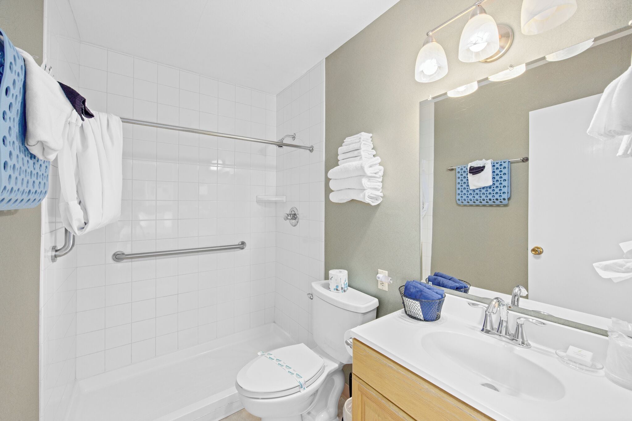 A modern bathroom with a shower, toilet, and sink.