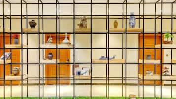 A wall with a grid of shelves displaying various decorative items.