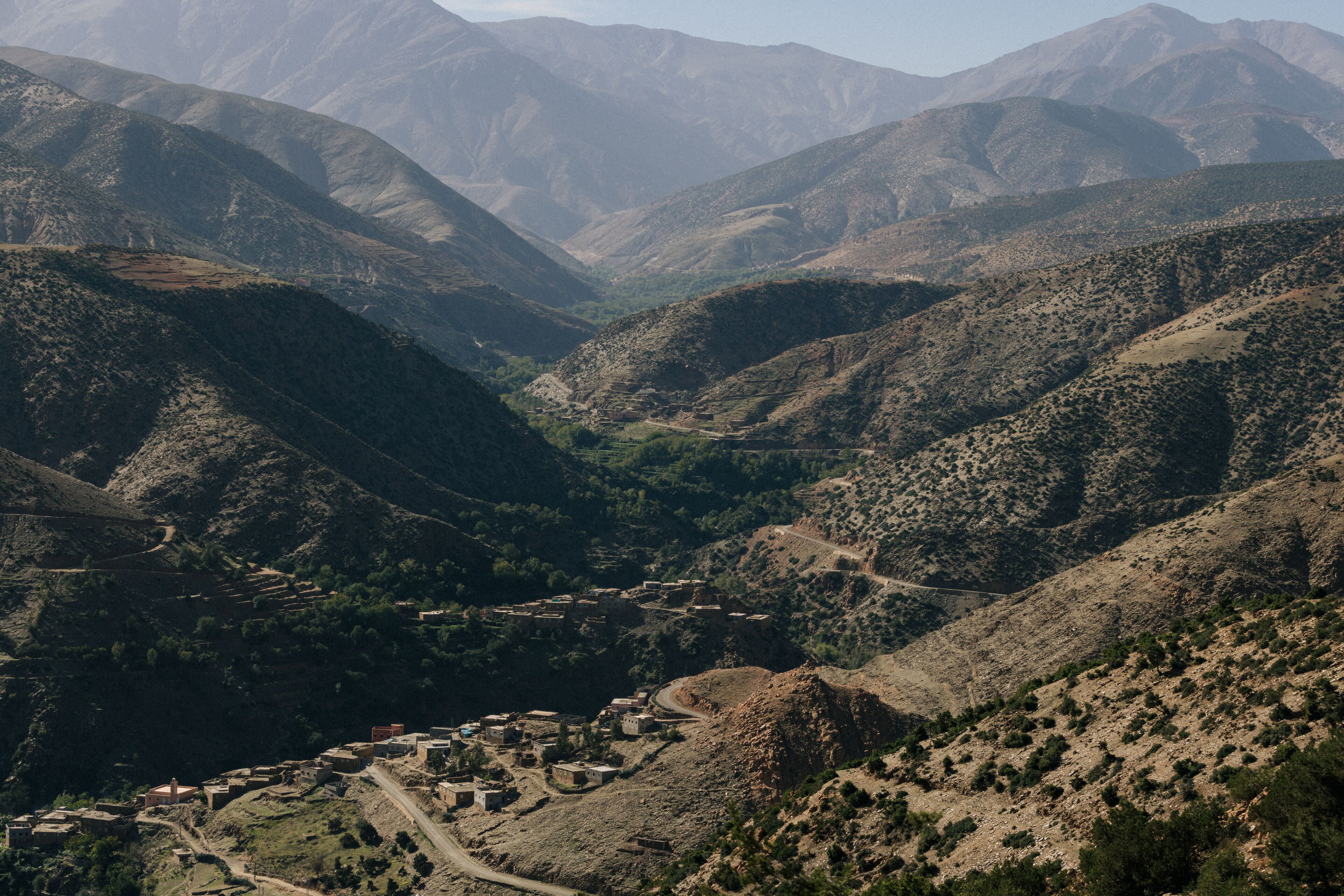 Un paisaje montañoso con un pueblo ubicado en un valle.