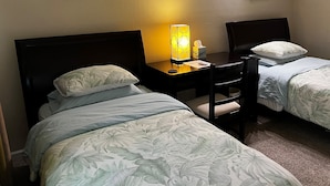 A hotel room with two beds, a desk with a lamp, and framed artwork on the walls. - Comfortable, convenient 2BR 2BA apt in Alameda (Alameda)