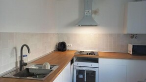 A kitchen with a sink, stove, oven, and a microwave. - HOLIDAY BEACH VACATIONS (El Puerto de Santa María)