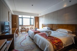 A hotel room with two beds, a TV, a desk, and a balcony. - Zheng Ming Hotel (Jingning)