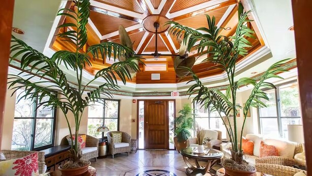 A spacious lobby with a high ceiling, large windows, and potted plants. - Stylish & Comfy ~ 5★ Location, Office, ♛Queen Bed (Ridgecrest)