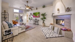 A modern living room with a sofa, armchairs, a coffee table, and a fireplace. - House Rising ☀️ Villa w/ mini-golf, pool and spa (Desert Hot Springs)