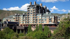 A multi-story hotel with a modern architectural design, featuring a prominent central tower and multiple balconies. - Westin Riverfront - Beaver Creek - 1 bedroom (Avon)