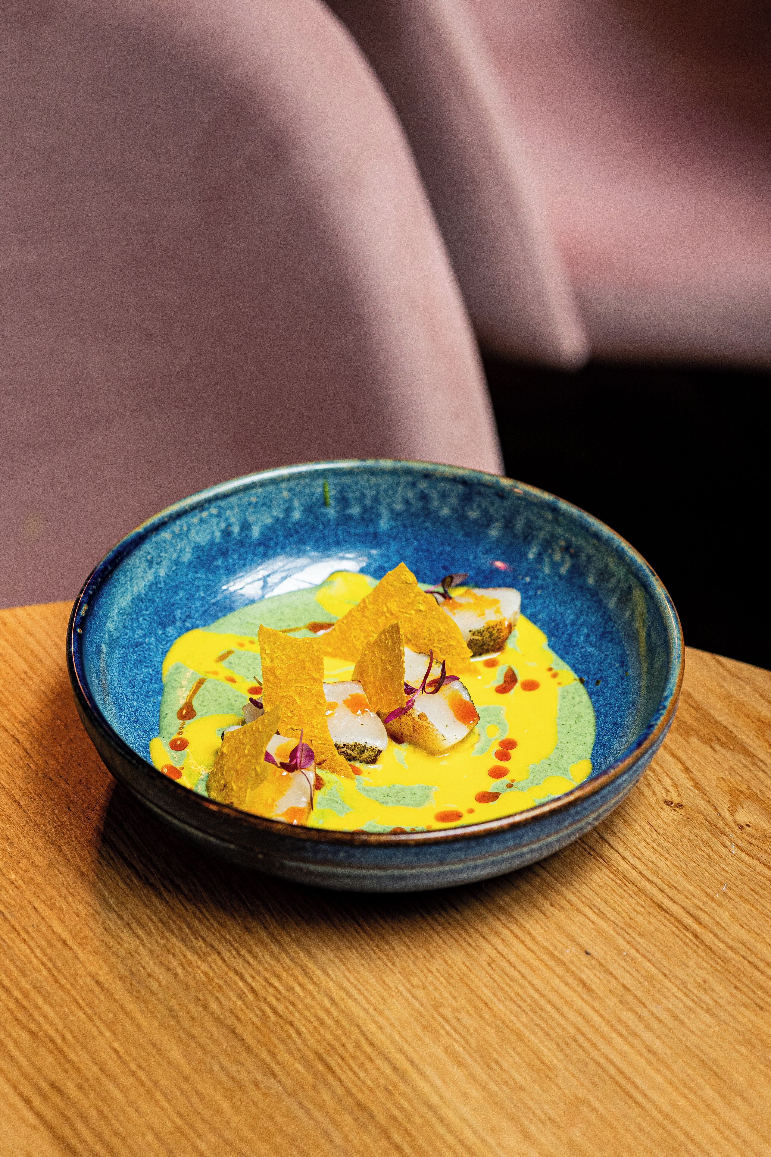 A bowl of food on a wooden table.