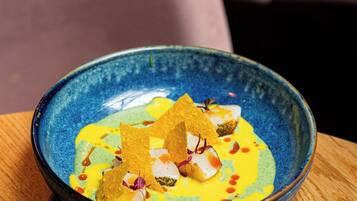 A bowl of food on a wooden table.